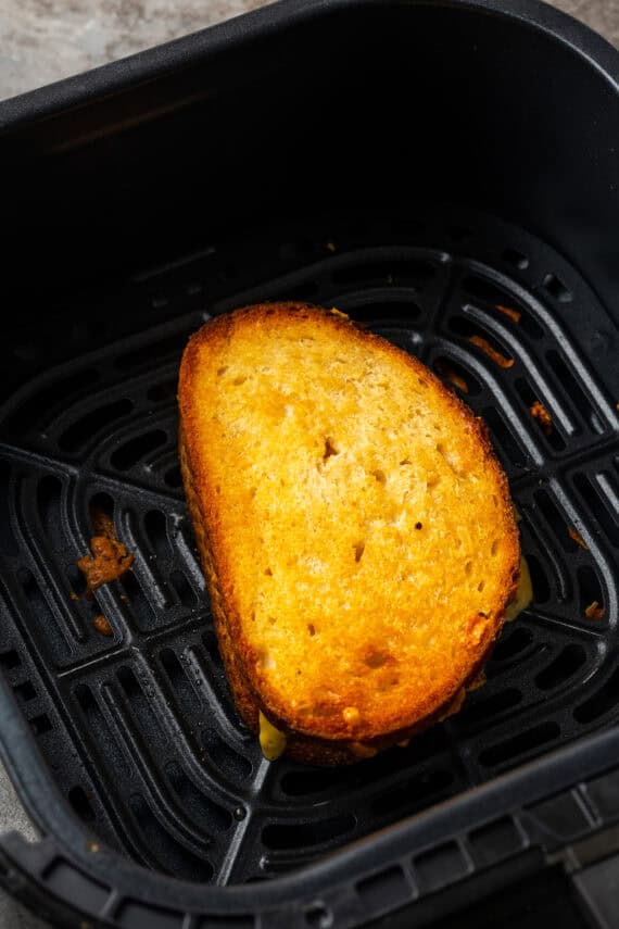 A grilled cheese sandwich inside the air fryer.