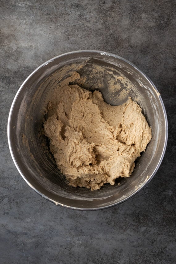 Chai sugar cookie dough in a metal mixing bowl.