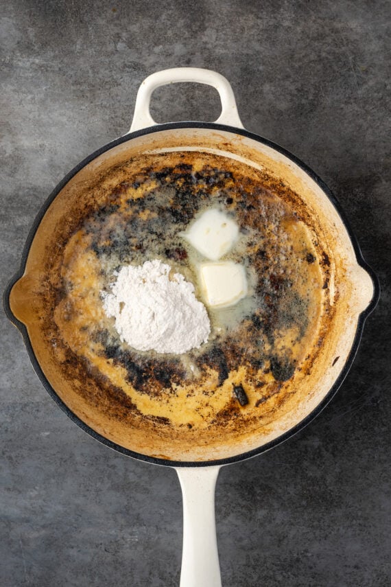 Flour added to melted butter in a skillet, to make a roux.