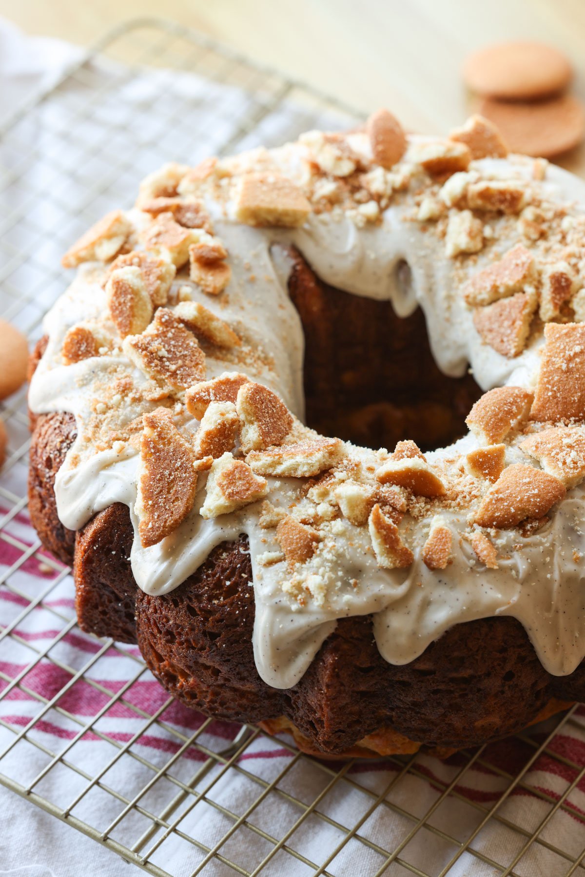 An iced banana cake garnished with shortbread cookies