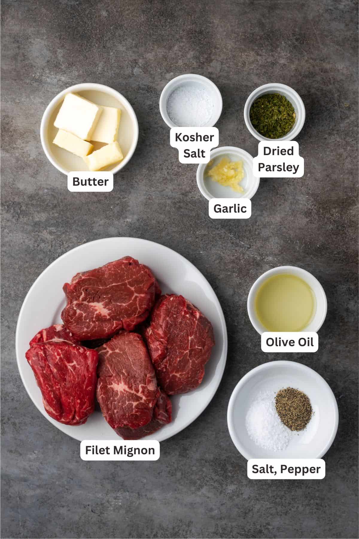 Make juicy, restaurant-quality air fryer filet mignon slathered with homemade garlic compound butter for the ultimate steak dinner! Air fryer filet mignon and compound butter ingredients with text labels overlaying each ingredient.
