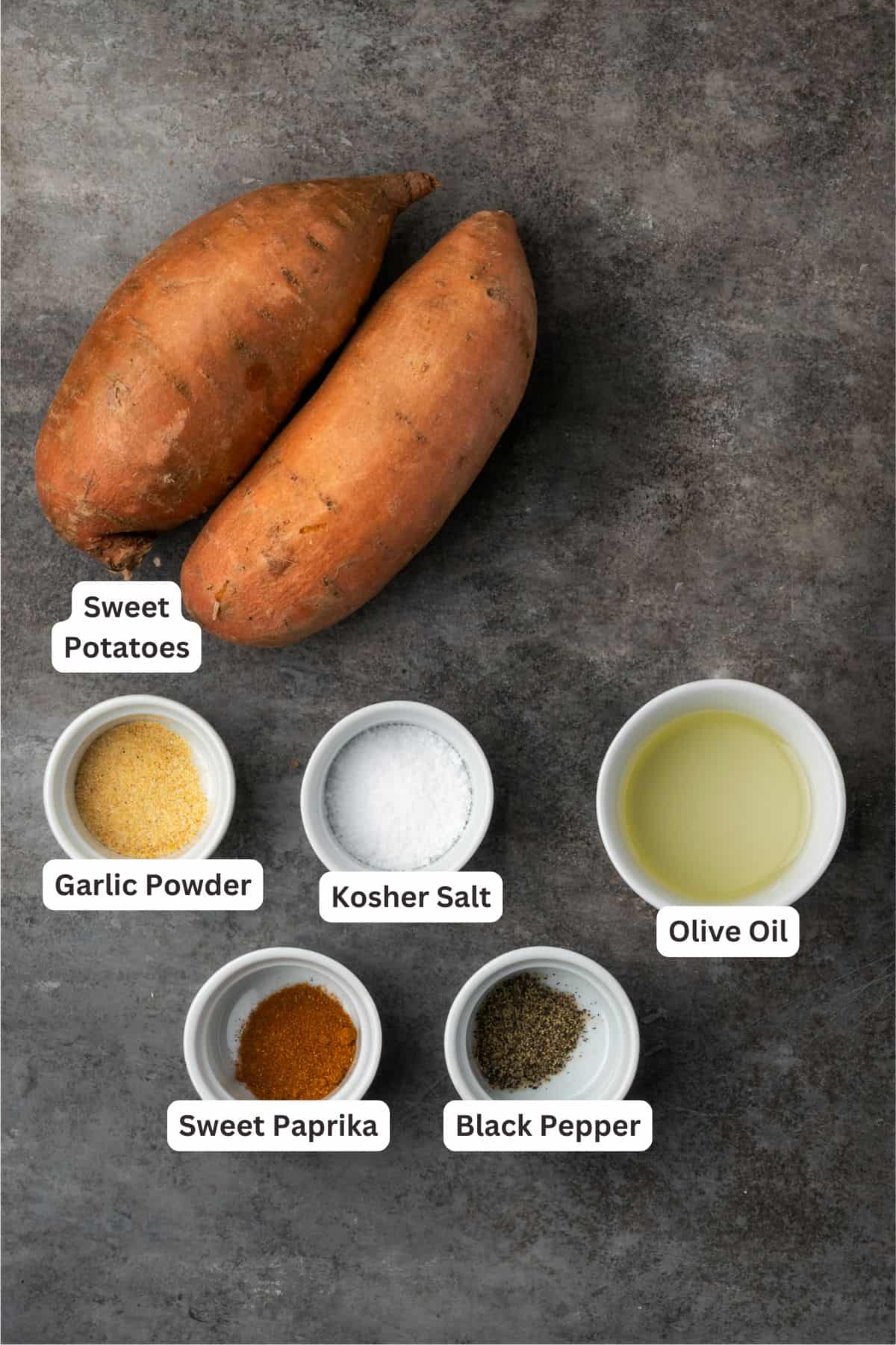 Seasoned with garlic and paprika, crispy air fryer sweet potato fries are tasty and easy to make. It's quicker and lighter than deep frying! Air fryer sweet potato fries ingredients with text labels overlaying each ingredient.