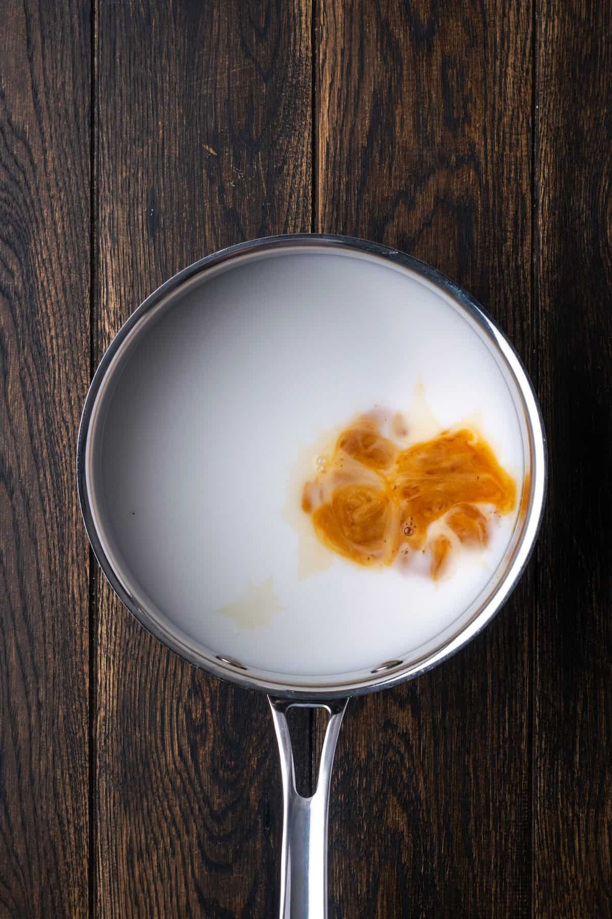 Milk and vanilla combined in a saucepan.