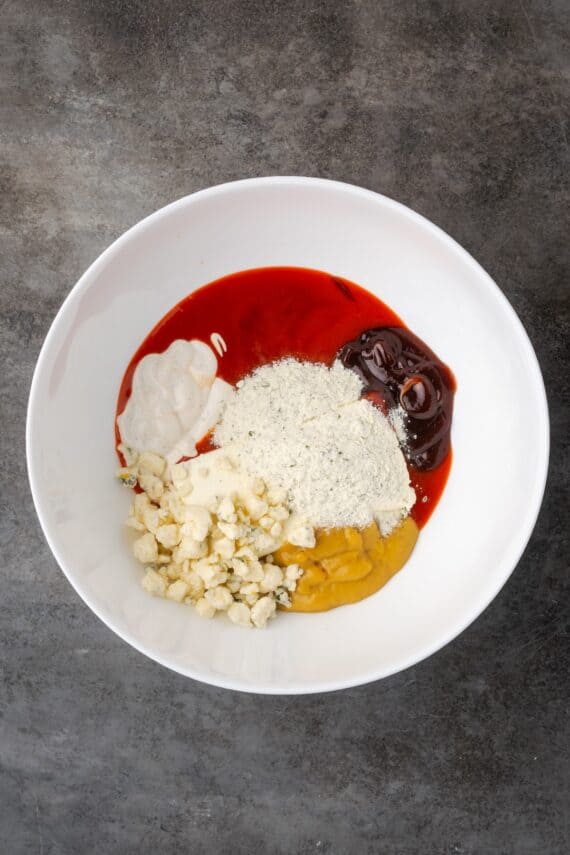 Buffalo dip ingredients combined in a bowl.