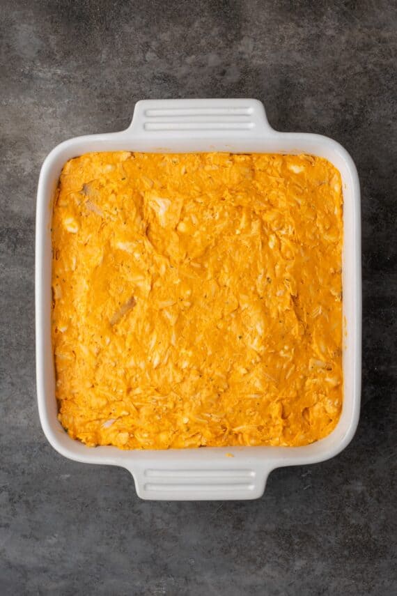 Baked buffalo chicken dip in a casserole dish.
