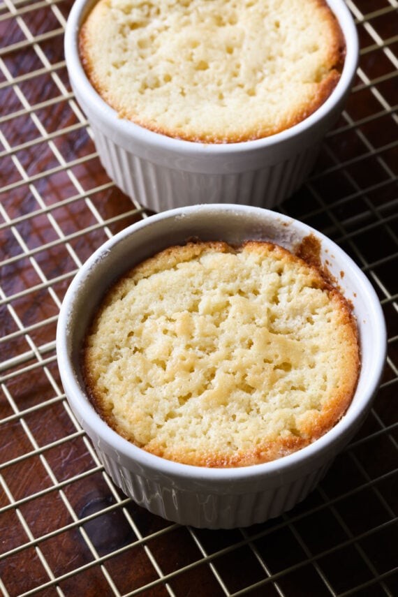 This insanely moist Copycat Butter Cake Recipe is a dupe for the Crumbl Butter Cake and the warm butter cake at California Pizza Kitchen. Butter cake baked in white ramekins on a wire rack to cool