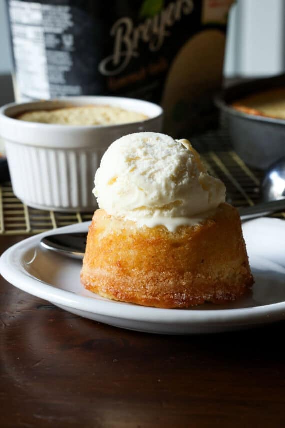 Ice cream melting on a copycat California pizza kitchen butter cake served on a white plate
