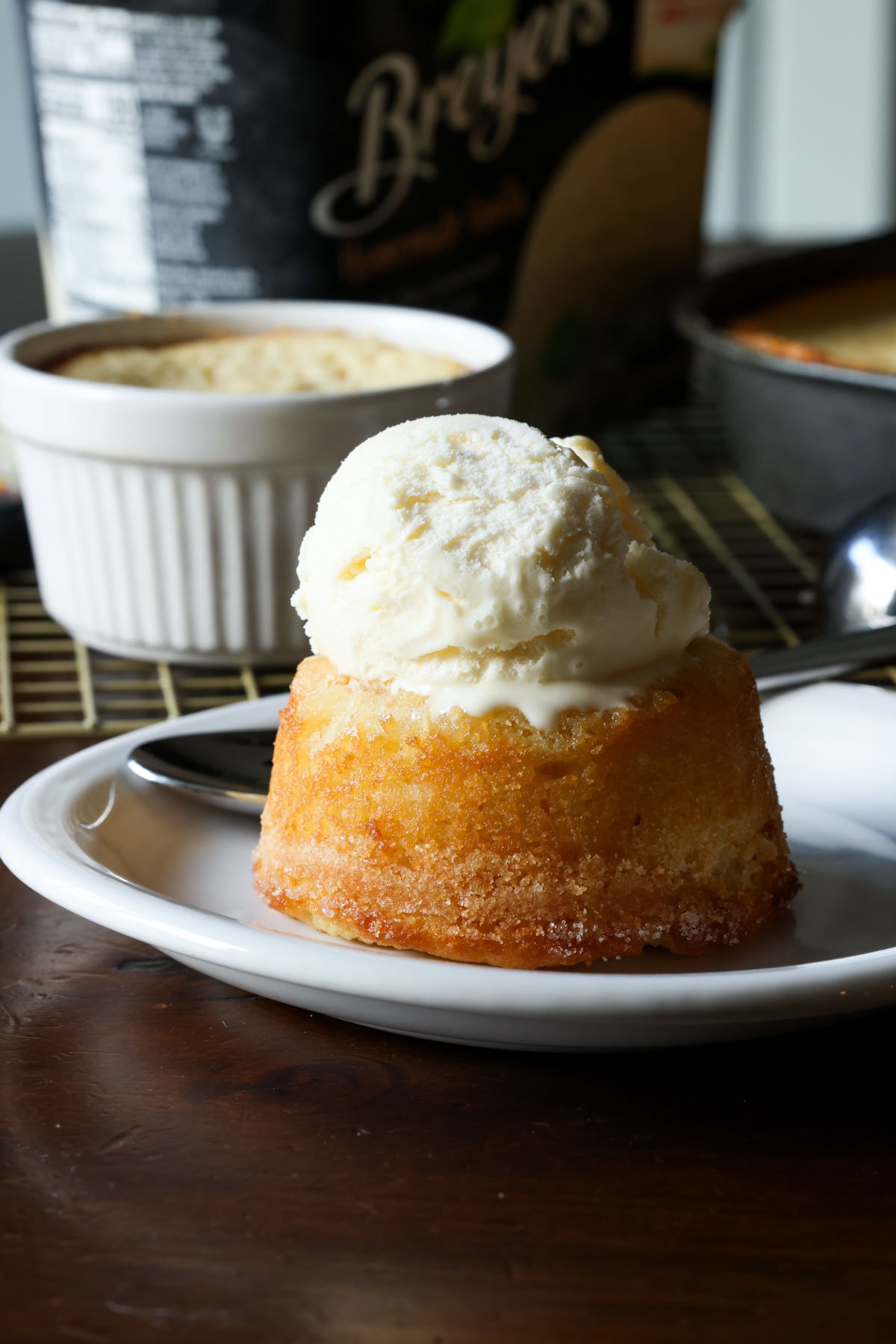 This insanely moist Copycat Butter Cake Recipe is a dupe for the Crumbl Butter Cake and the warm butter cake at California Pizza Kitchen. Ice cream melting on a copycat California pizza kitchen butter cake served on a white plate