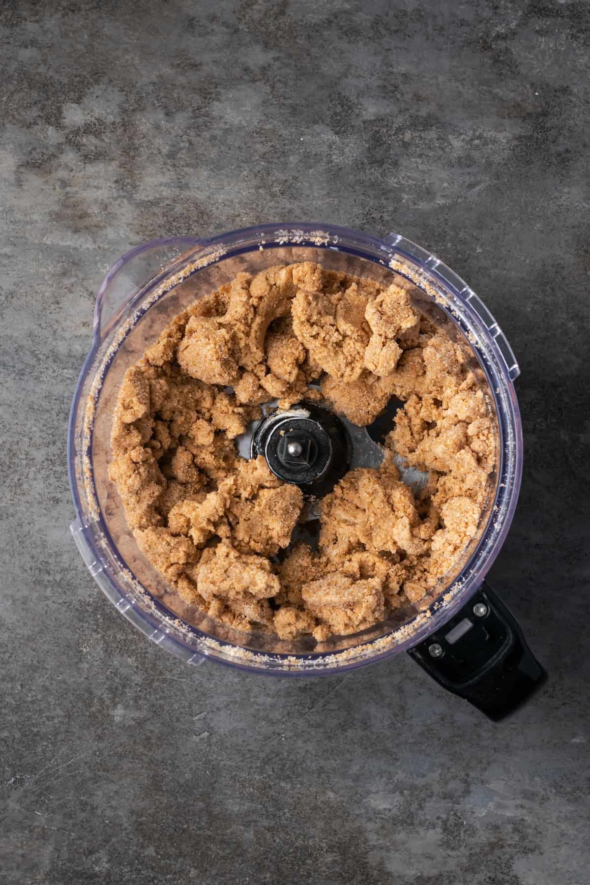 This easy apple brown betty is an old-fashioned dessert recipe with gooey baked apples layered with a buttery, sweet cinnamon crumble. Cinnamon crumble inside a food processor.