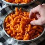 A hand grabbing some Caramel Cheetos