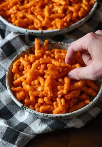 A hand grabbing some Caramel Cheetos