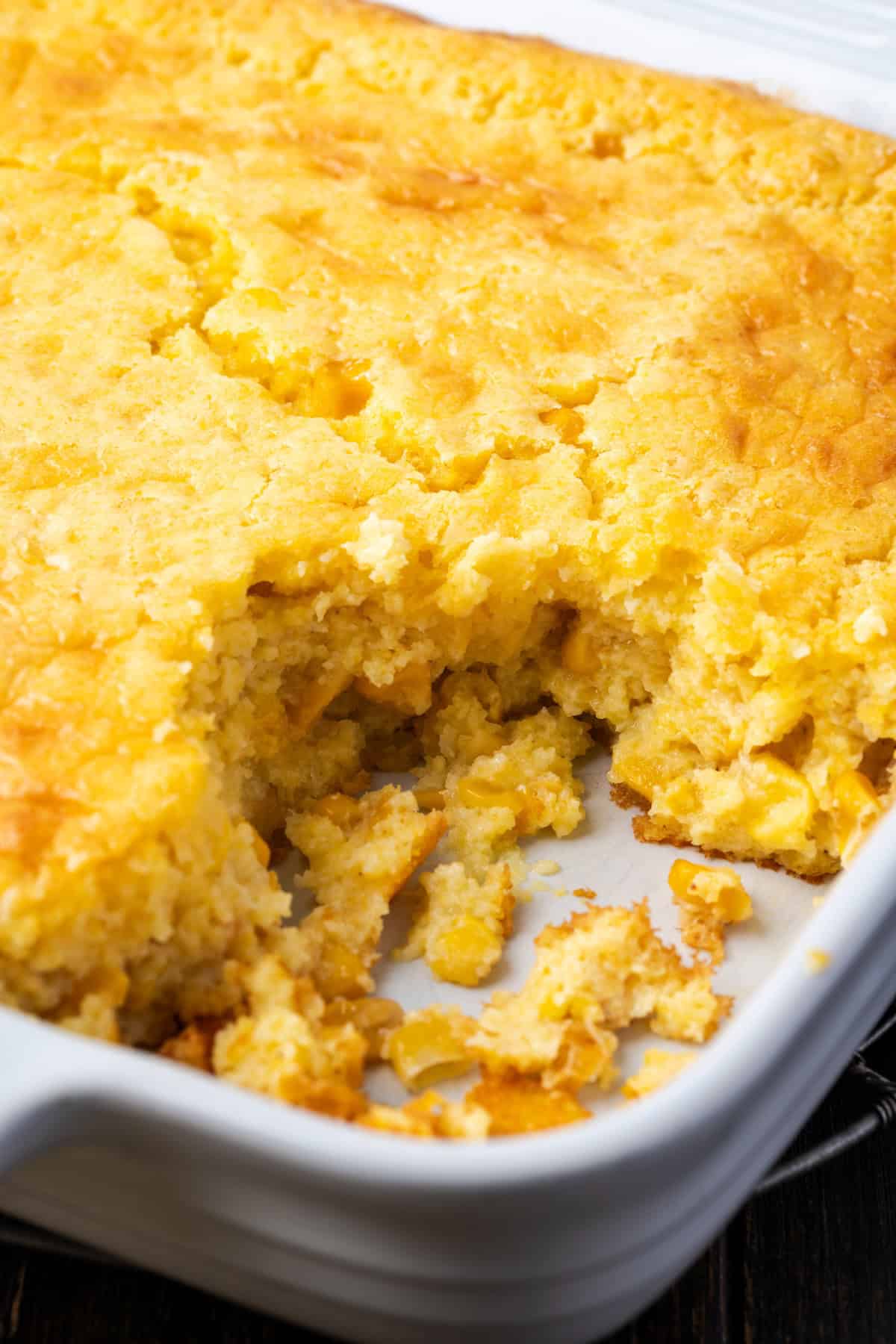 Old-fashioned spoon bread is a soft, creamy twist on cornbread that you eat with a spoon! It's a comforting Southern side dish for any meal. Spoon bread in a baking dish with a serving missing from the corner.