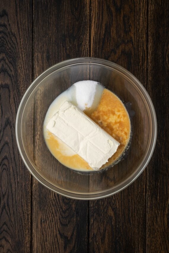Cheesecake dip ingredients combined i a bowl.