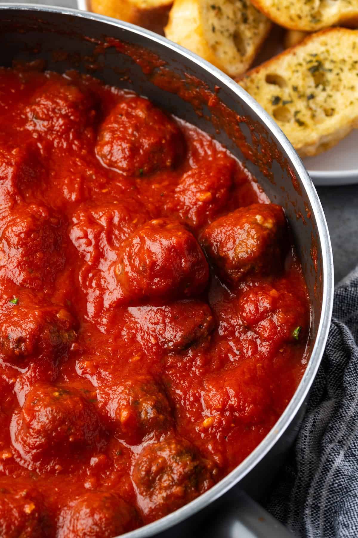 Air fryer meatballs with sauce in a saucepan.