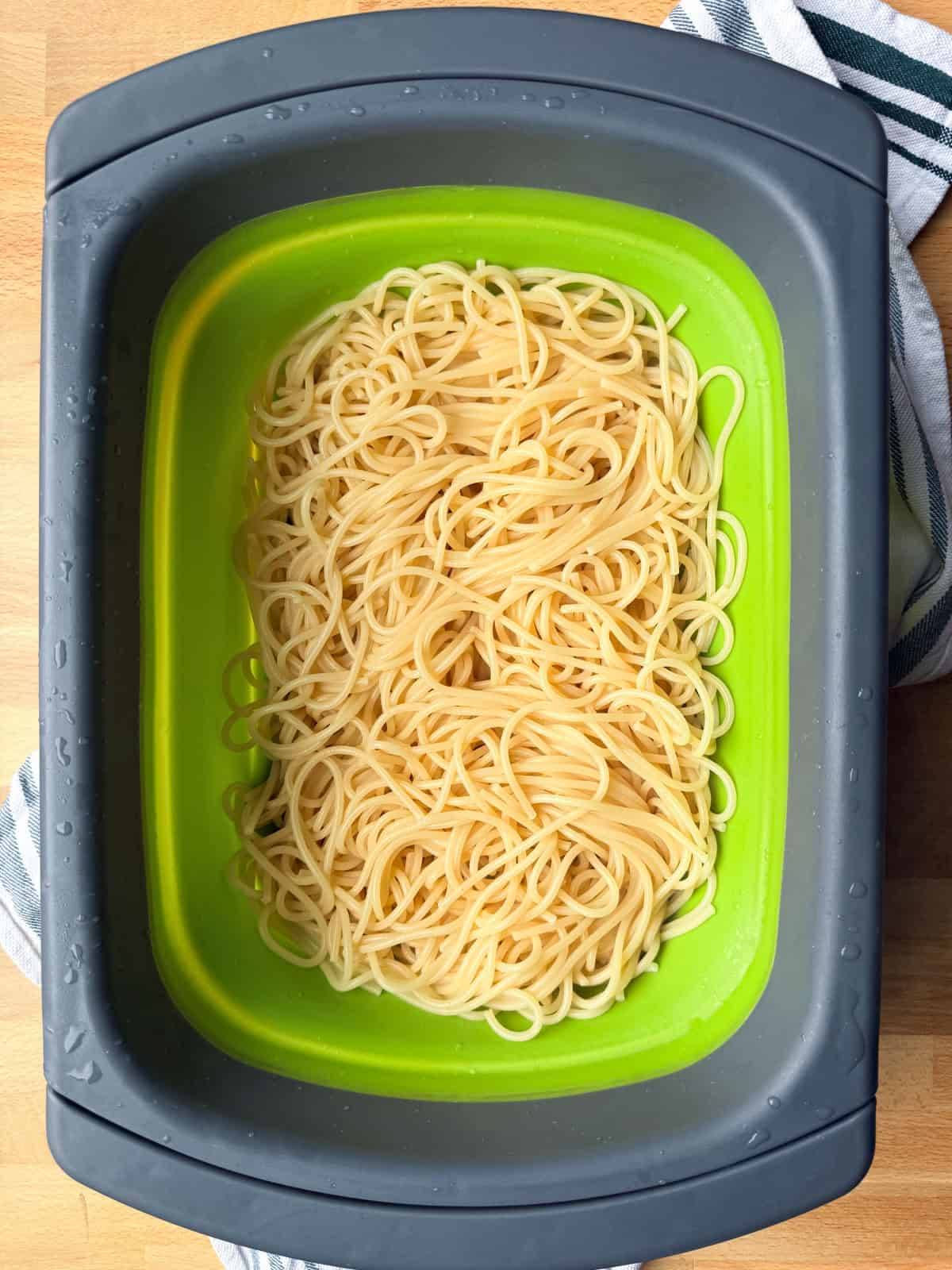 Creamy chicken tetrazzini is an easy pasta bake that's ready in under an hour! Made with juicy chicken and spaghetti in a rich cream sauce. Cooked and drained spaghetti noodles in a colander.