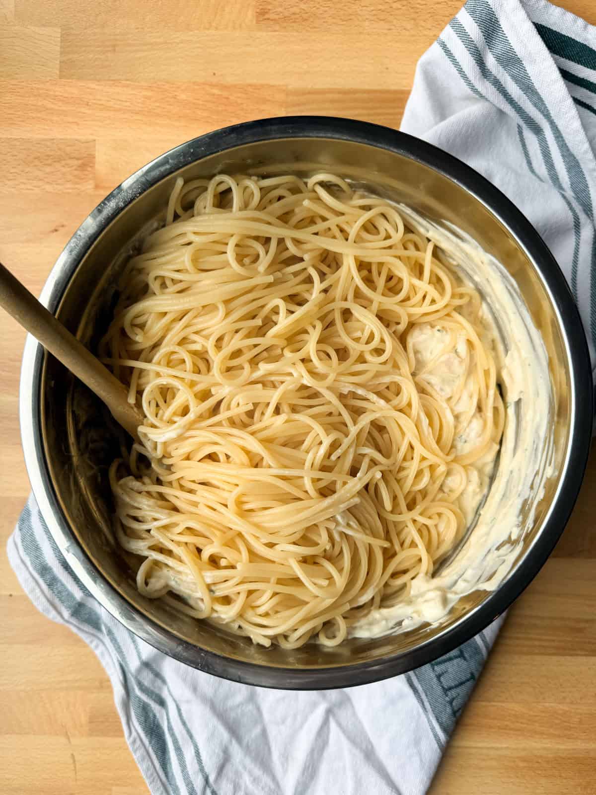 Creamy chicken tetrazzini is an easy pasta bake that's ready in under an hour! Made with juicy chicken and spaghetti in a rich cream sauce. Spaghetti added to a bowl of creamy chicken mixture.