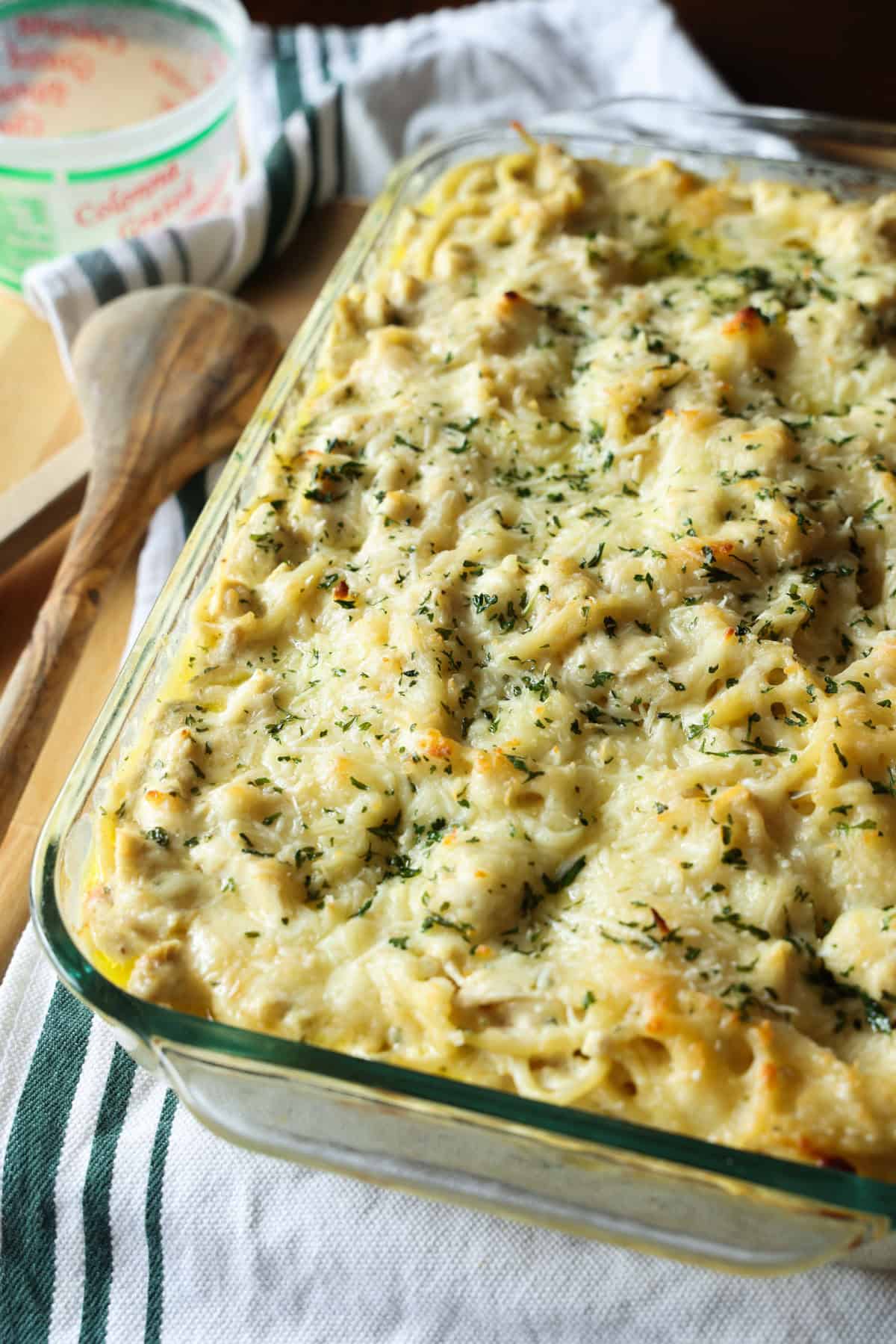 Creamy chicken tetrazzini is an easy pasta bake that's ready in under an hour! Made with juicy chicken and spaghetti in a rich cream sauce. Freshly baked cheesy chicken tetrazzini in a glass casserole dish.
