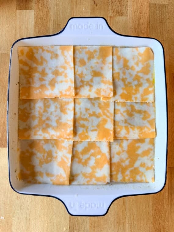 Covering a beef casserole with colby jack cheese slices