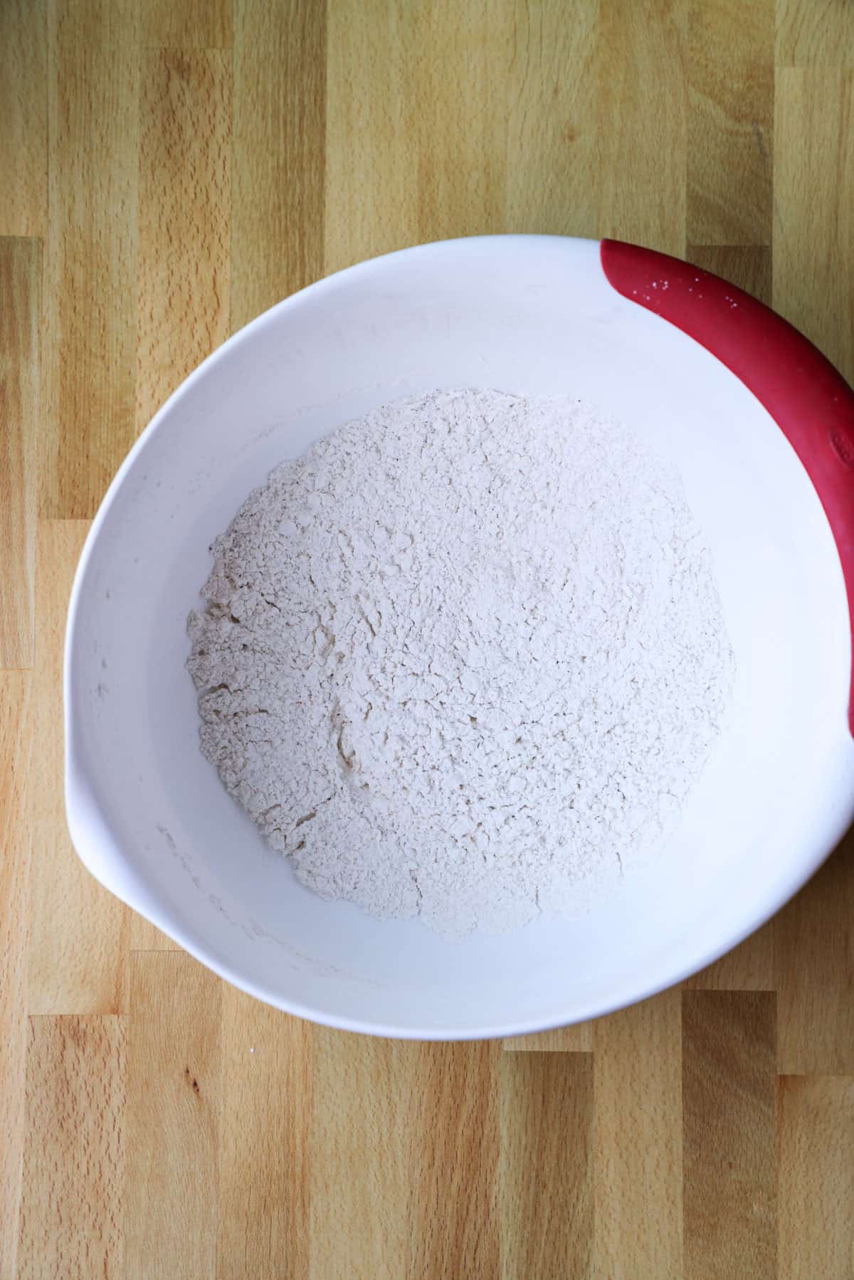 This copycat PF Chang’s spicy chicken recipe is a quick and delicious sweet and spicy stir-fry! Make it in one skillet and serve it with rice. Flour and seasonings combined in a bowl.