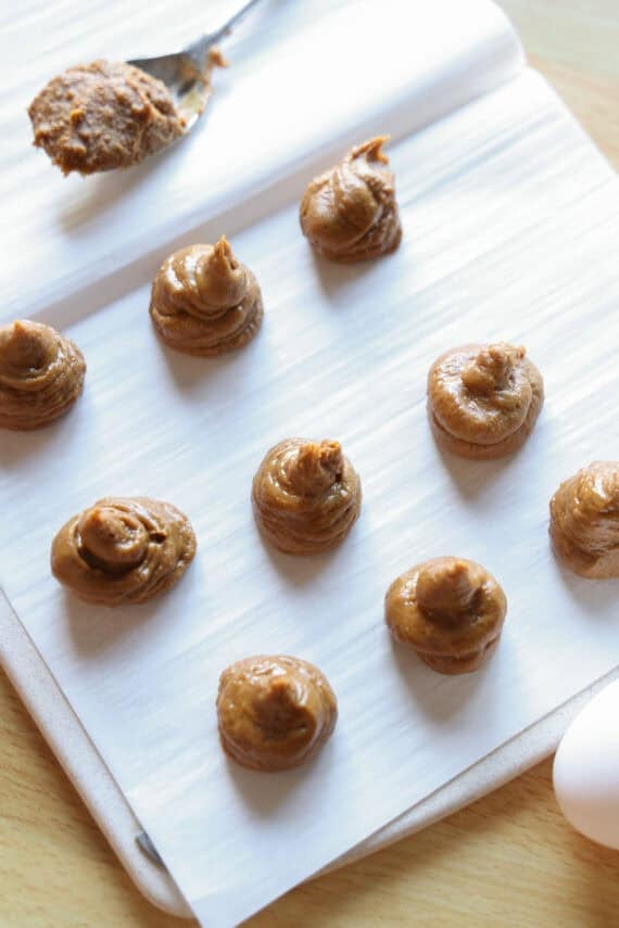 Swirls of Biscoff spread on a parchment lined plate.