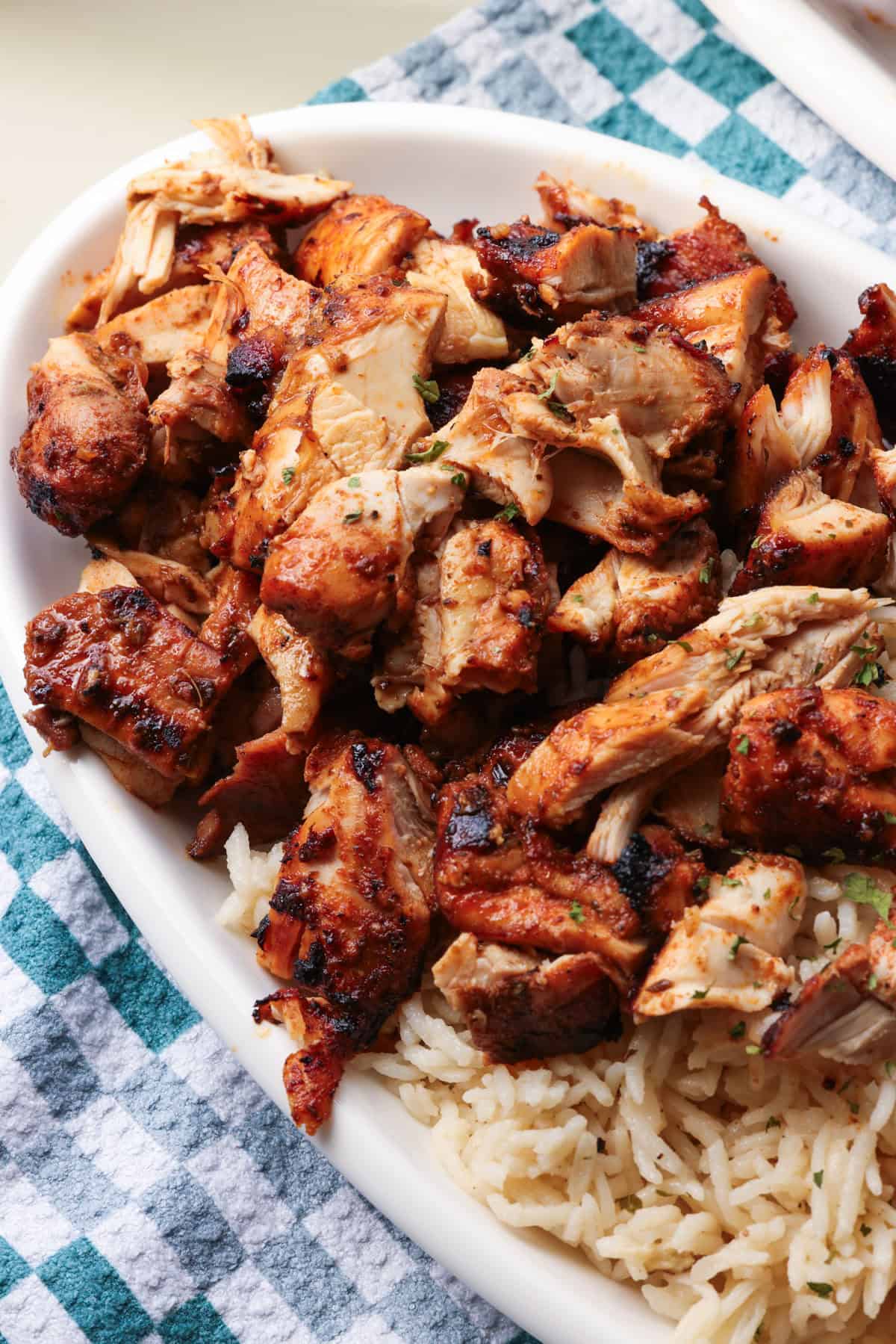 Chopped Chipotle chicken served next to rice on a plate.