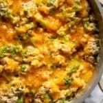 Overhead view of cheesy chicken broccoli and rice in a skillet.