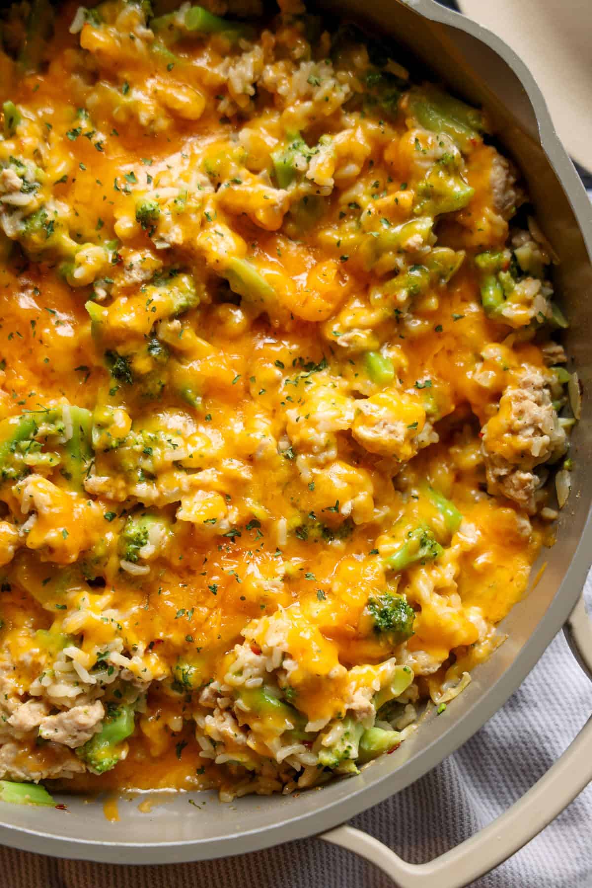 Overhead view of cheesy chicken broccoli and rice in a skillet.