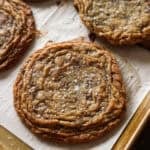 Giant Crinkled Chocolate Chip Cookies on a parchment lined baking sheet