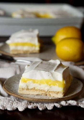 A slice of layered Lemon Lush dessert on a plate