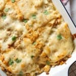Chicken Enchilada Casserole in a white baking dish topped with melted cheese