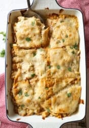 Chicken Enchilada casserole baked in a 9x13 baking dish.
