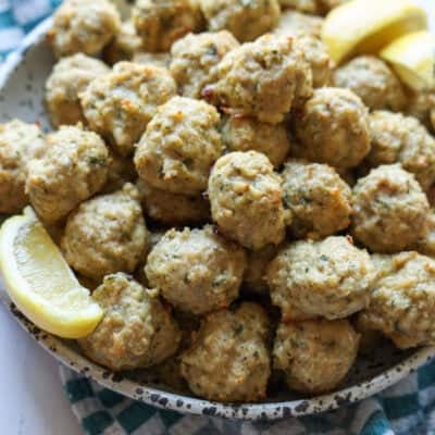 Chicken Meatballs in a bowl garnished with lemon slices