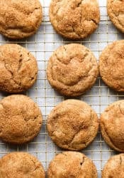 Cinnamon sugar coated churro cookies cooling on a wire rack.