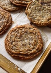 Giant Crinkled Chocolate Chip Cookies on a parchment lined baking sheet