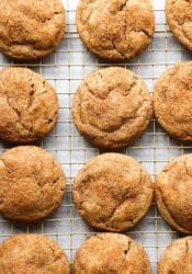 Cinnamon sugar coated churro cookies cooling on a wire rack.