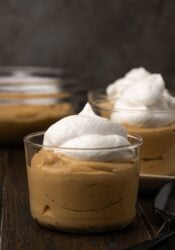 Bourbon butterscotch pudding served in glasses topped with whipped cream.