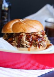 Root beer pulled pork sandwich on a red serving tray