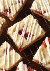 Strawberry Shortbread Bars drizzled with glaze.