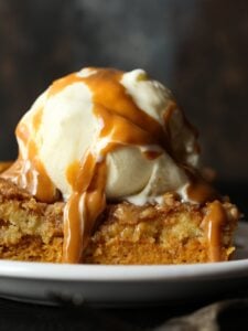 Pumpkin Dump Cake image with ice cream and caramel sauce