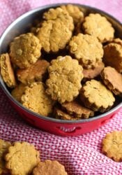 A dog bowl filled to the brim with homemade dog treats.