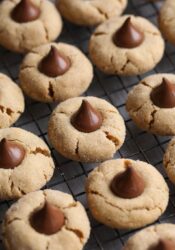 Thirteen Peanut Butter Blossom Cookies Lined Up on a Metal Rack