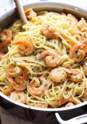 Pan full of shrimp and linguine.