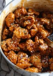 Sesame chicken in a bowl coated with sauce