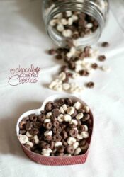 Overhead view of chocolate covered cheerios in a heart-shaped dish